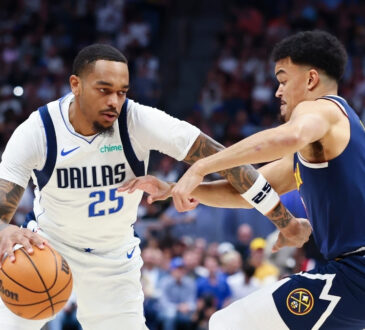 P.J. Washington (#25) of the Dallas Mavericks drives to the basket against the Denver Nuggets during the first quarter at Ball Arena.