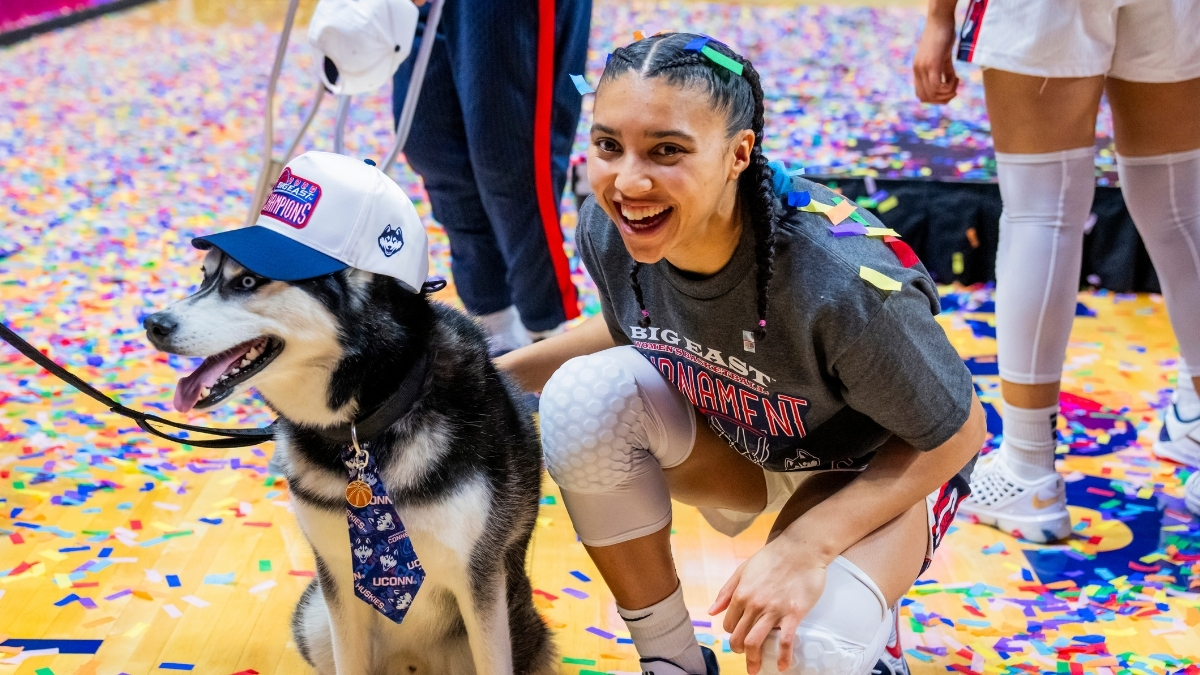 Azzi Fudd #35 of the UConn Huskies poses with Jonathan the Husky mascot after winning the Big East Tournament championship against Villanova.