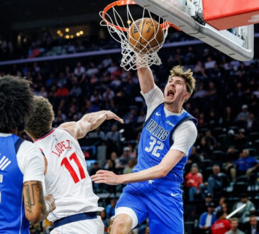 Cooper Flagg #32 of the Dallas Mavericks throws down a slam dunk over Brook Lopez #11 of the Los Angeles Clippers at Intuit Dome.