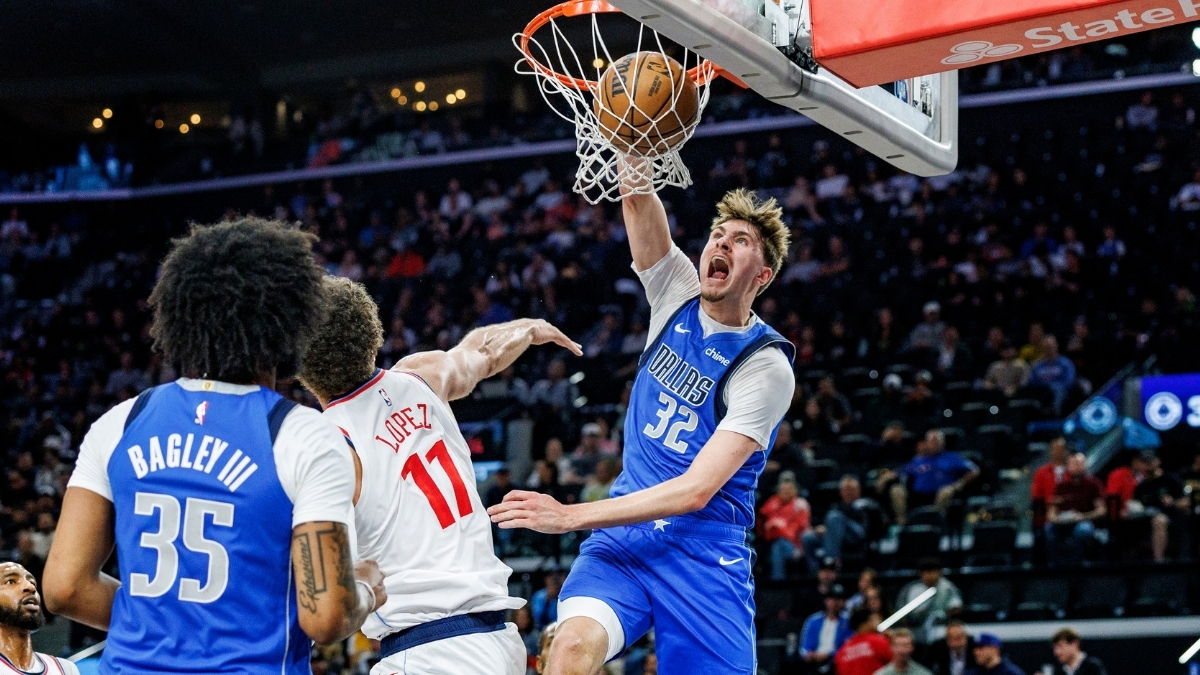 Cooper Flagg #32 of the Dallas Mavericks throws down a slam dunk over Brook Lopez #11 of the Los Angeles Clippers at Intuit Dome.