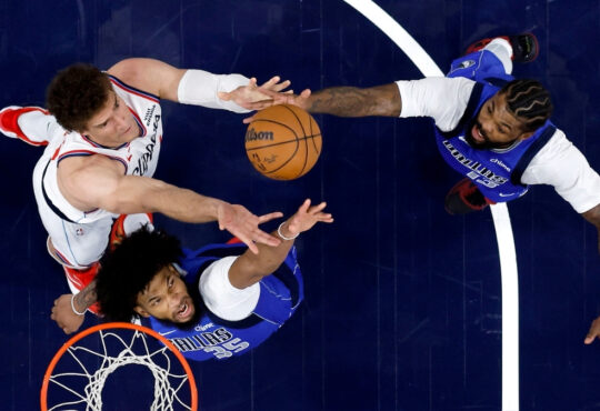 Marvin Bagley III #35 and Naji Marshall #13 of the Dallas Mavericks battle Brook Lopez #11 of the Los Angeles Clippers for a rebound during the first half at Intuit Dome.