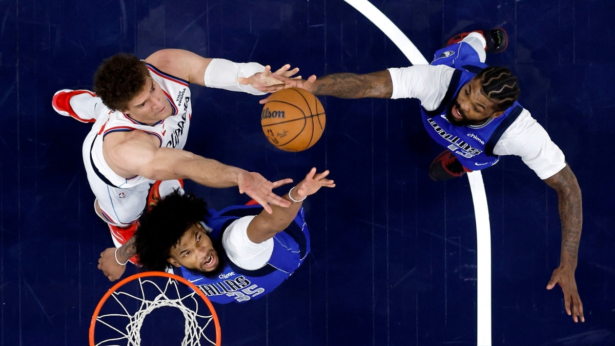 Marvin Bagley III #35 and Naji Marshall #13 of the Dallas Mavericks battle Brook Lopez #11 of the Los Angeles Clippers for a rebound during the first half at Intuit Dome.