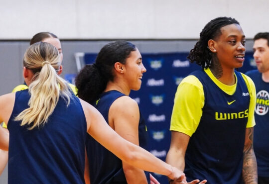 Dallas Wings guards Paige Bueckers, Azzi Fudd, and Zee Spearman on the practice court during training camp in Arlington.