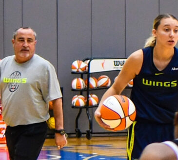 Dallas Wings star Paige Bueckers handles the ball in transition while head coach Jose Fernandez watches from the sideline at College Park Center.