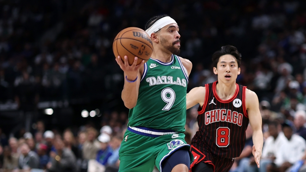 Ryan Nembhard #9 of the Dallas Mavericks drives past Yuki Kawamura #8 of the Chicago Bulls at American Airlines Center.
