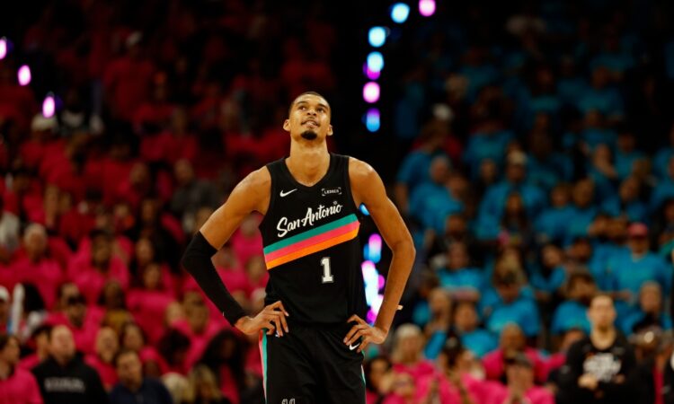 Victor Wembanyama #1 of the San Antonio Spurs looks at the clock during Game 1 of the Western Conference First Round against the Portland Trail Blazers at Frost Bank Center on April 19, 2026.