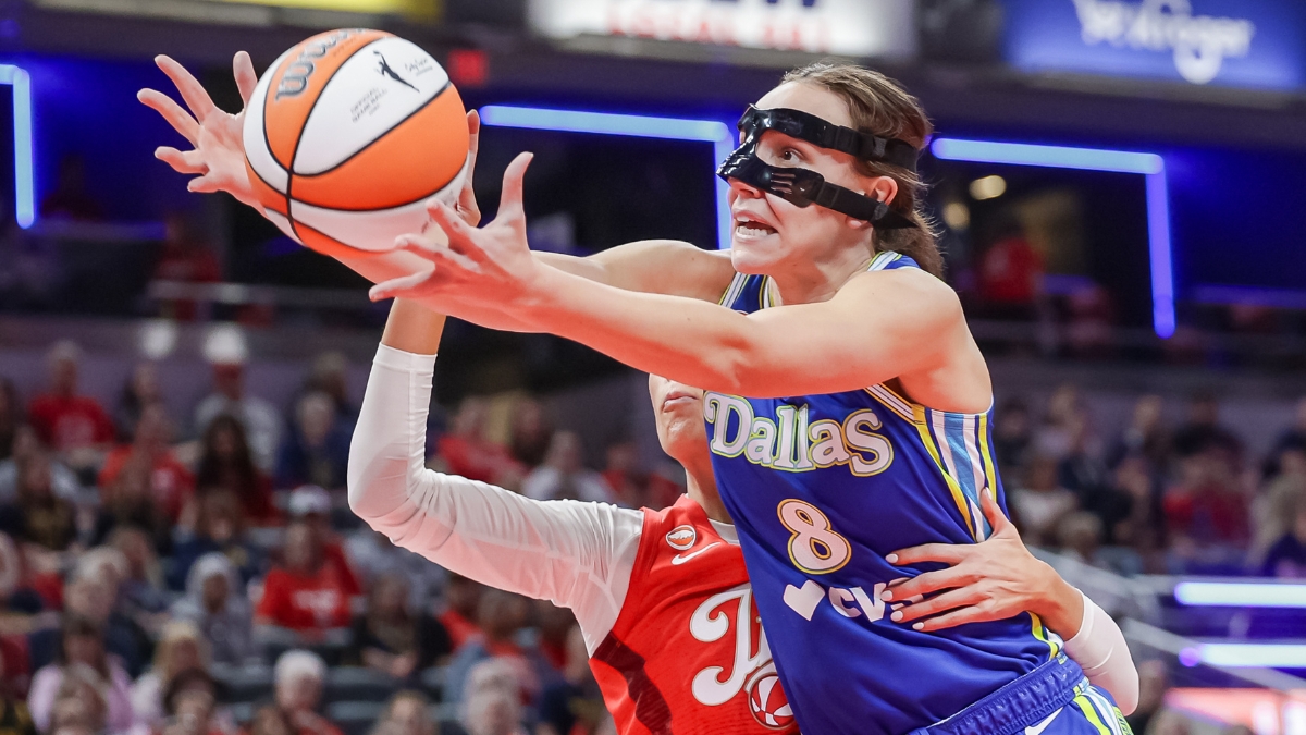 Alanna Smith (8) of the Dallas Wings reaches for a loose ball against Sophie Cunningham (8) of the Indiana Fever.