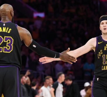 LeBron James #23 and Austin Reaves #15 of the Los Angeles Lakers high five during the fourth quarter of Game 4 of the Western Conference Second Round against the Oklahoma City Thunder at Crypto.com Arena on May 11, 2026.