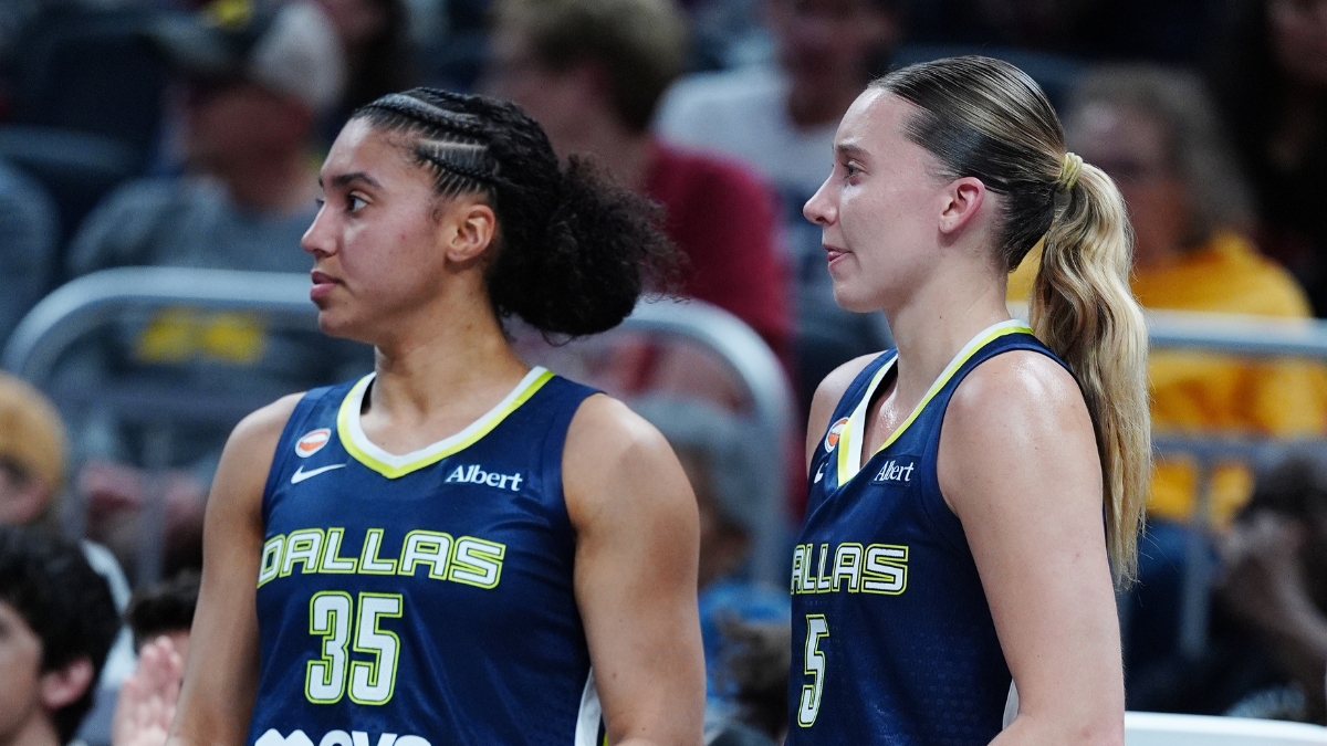 Paige Bueckers and Azzi Fudd watching from the bench during the Mavericks' preseason game against the Indiana Fever.