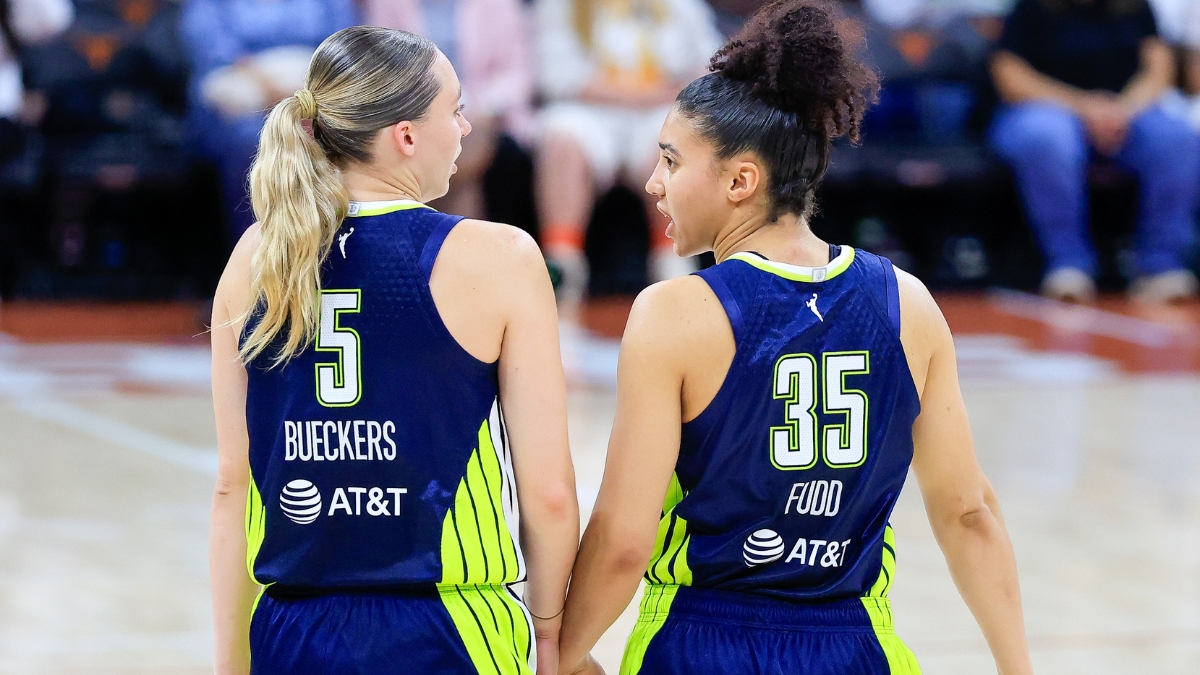 Paige Bueckers and Azzi Fudd talking on the court during the Wings vs. Aces preseason game.