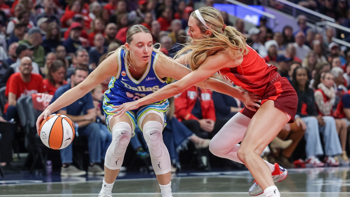 Paige Bueckers (5) of the Dallas Wings dribbles against Lexie Hull (10) of the Indiana Fever at Gainbridge Fieldhouse.