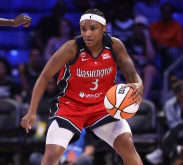 Washington Mystics guard Rori Harmon driving the ball along the perimeter as Dallas Wings forward Awak Kuier uses her length to close down the lane defensively.