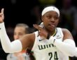 Dallas Wings guard Arike Ogunbowale celebrating a three-point basket during a game against the Seattle Storm at Climate Pledge Arena.