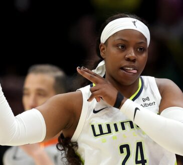 Dallas Wings guard Arike Ogunbowale celebrating a three-point basket during a game against the Seattle Storm at Climate Pledge Arena.