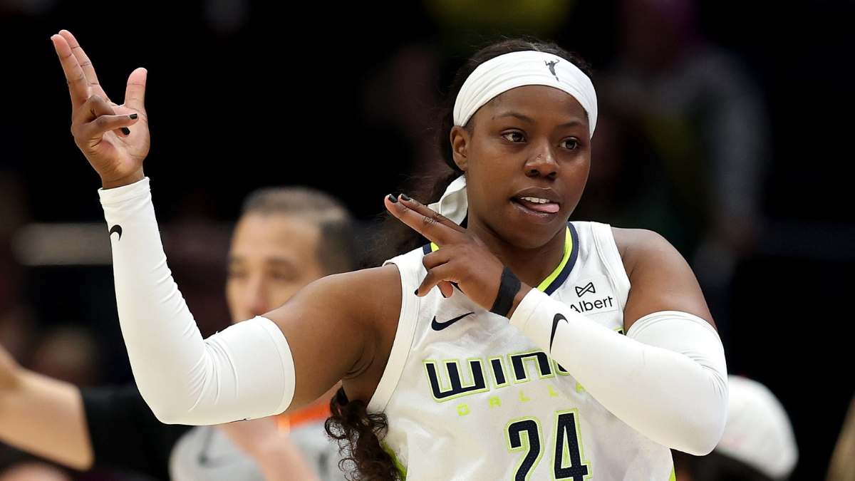 Dallas Wings guard Arike Ogunbowale celebrating a three-point basket during a game against the Seattle Storm at Climate Pledge Arena.