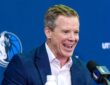 Dusty May smiles while answering questions at the podium during his introductory press conference as Dallas Mavericks head coach.