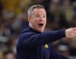 Michigan coach Dusty May shouts and points from the sideline during a game.