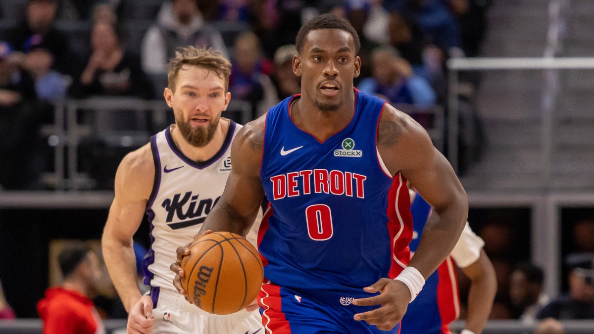 Detroit Pistons center Jalen Duren dribbles the ball up court ahead of Sacramento Kings forward Domantas Sabonis during a game at Little Caesars Arena