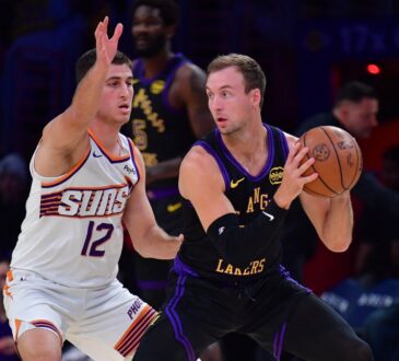 Los Angeles Lakers guard Luke Kennard controls the ball while defended by Phoenix Suns guard Collin Gillespie during a game at Crypto.com Arena