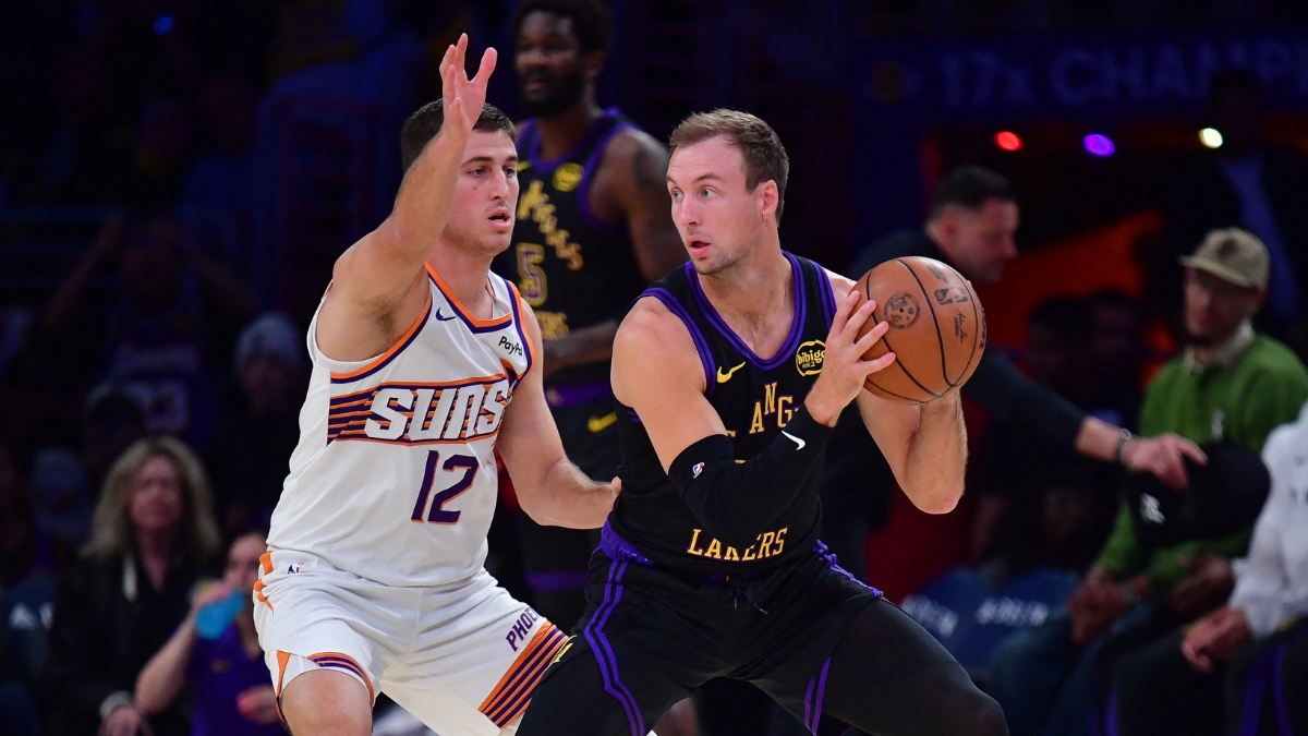 Los Angeles Lakers guard Luke Kennard controls the ball while defended by Phoenix Suns guard Collin Gillespie during a game at Crypto.com Arena