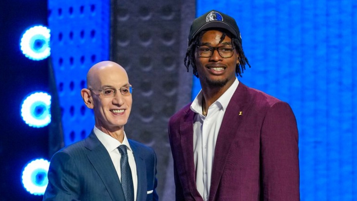 Morez Johnson Jr. wears a Dallas Mavericks cap and shakes hands with NBA Commissioner Adam Silver on stage after being selected No. 9 in the 2026 NBA Draft.