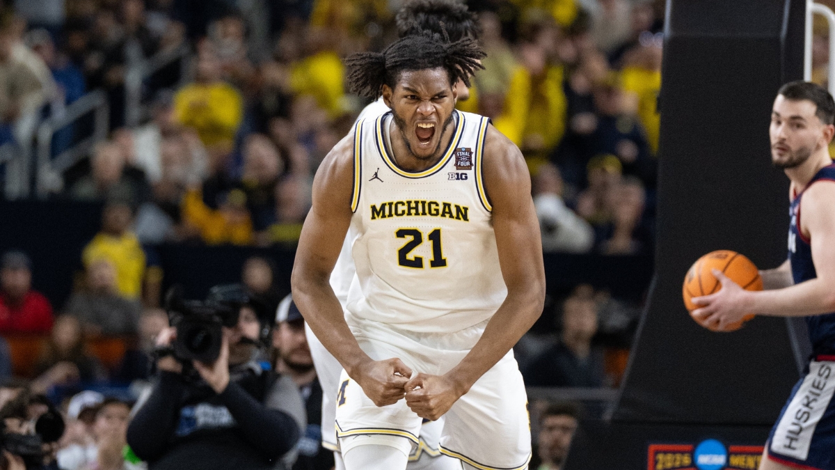 Morez Johnson Jr. flexes and celebrates in a white Michigan No. 21 jersey during the 2026 NCAA national championship game against UConn
