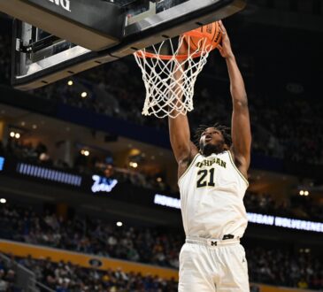 Morez Johnson Jr. throws down a two-handed dunk in a white Michigan No. 21 jersey during the 2026 NCAA Tournament