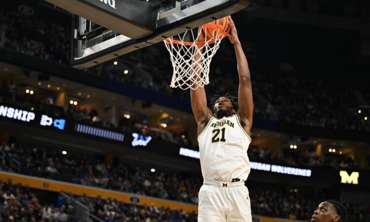 Morez Johnson Jr. throws down a two-handed dunk in a white Michigan No. 21 jersey during the 2026 NCAA Tournament