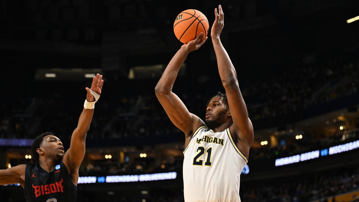Morez Johnson Jr. rises for a jump shot in a white Michigan No. 21 jersey over a Howard defender during the 2026 NCAA Tournament