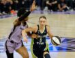 Dallas Wings guard Paige Bueckers, No. 5, drives the ball to her right against a Golden State Valkyries defender at Chase Center.
