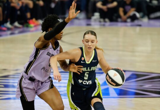 Dallas Wings guard Paige Bueckers, No. 5, drives the ball to her right against a Golden State Valkyries defender at Chase Center.