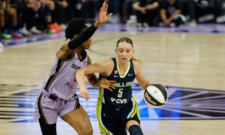 Dallas Wings guard Paige Bueckers, No. 5, drives the ball to her right against a Golden State Valkyries defender at Chase Center.