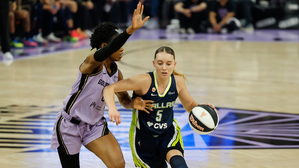 Dallas Wings guard Paige Bueckers, No. 5, drives the ball to her right against a Golden State Valkyries defender at Chase Center.
