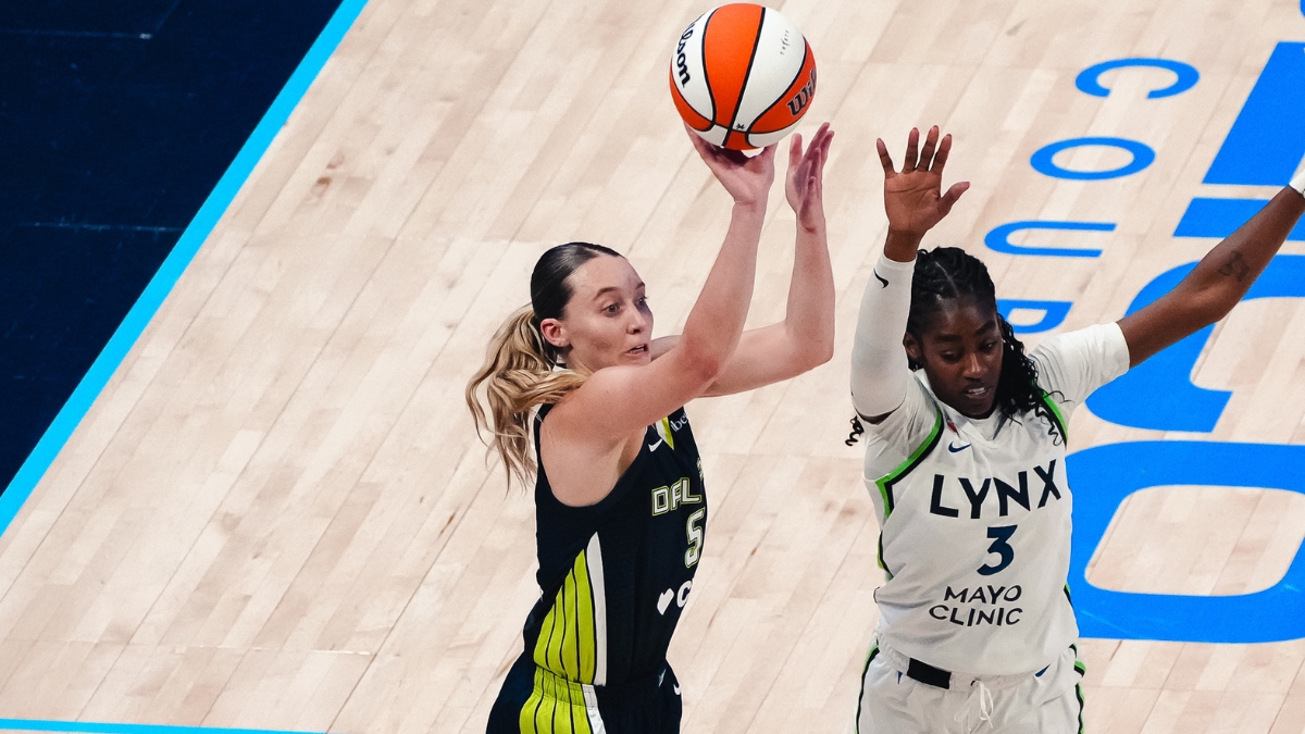 Dallas Wings guard Paige Bueckers rises for a jump shot over Minnesota Lynx guard Maya Caldwell during a WNBA game.