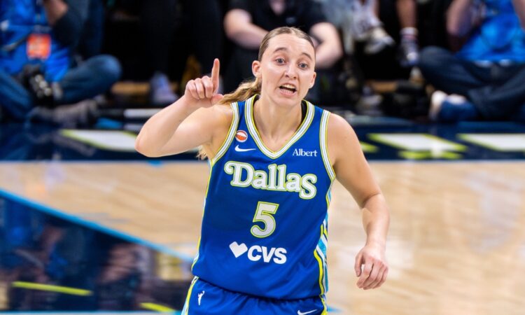 Paige Bueckers gestures in a blue Dallas Wings uniform near teammate Jessica Shepard during a game against the Atlanta Dream on May 12, 2026