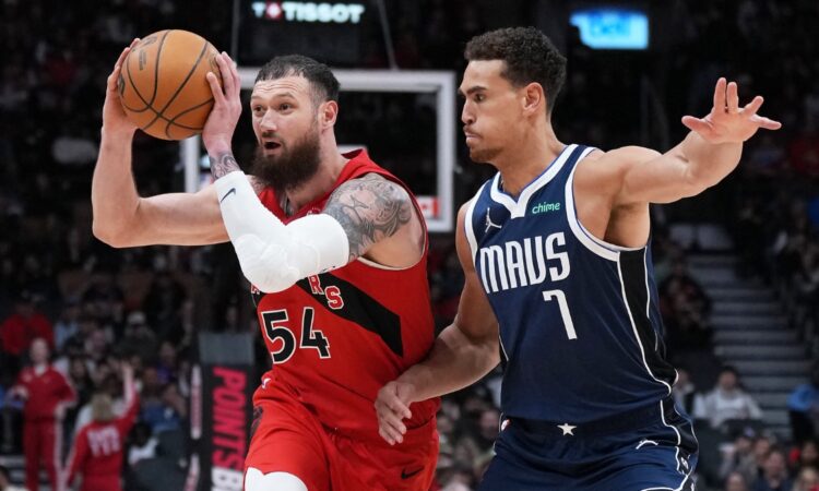 Toronto Raptors forward Sandro Mamukelashvili controls the ball as Dallas Mavericks forward Dwight Powell defends at Scotiabank Arena