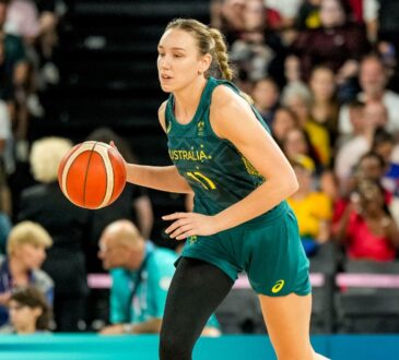 Australia forward Alanna Smith dribbles up the court in a green Opals uniform during the Paris 2024 Olympic semifinal against the United States.