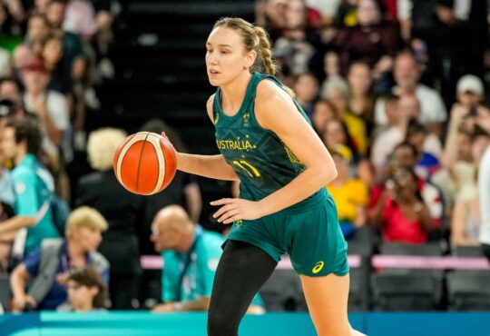 Australia forward Alanna Smith dribbles up the court in a green Opals uniform during the Paris 2024 Olympic semifinal against the United States.