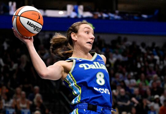 Dallas Wings forward Alanna Smith leaps to keep the ball in bounds against the Chicago Sky at American Airlines Center.