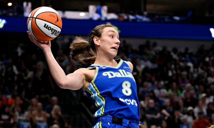 Dallas Wings forward Alanna Smith leaps to keep the ball in bounds against the Chicago Sky at American Airlines Center.