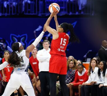 Atlanta Dream guard Allisha Gray shoots over the contest of Dallas Wings guard Arike Ogunbowale at College Park Center