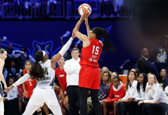 Atlanta Dream guard Allisha Gray shoots over the contest of Dallas Wings guard Arike Ogunbowale at College Park Center