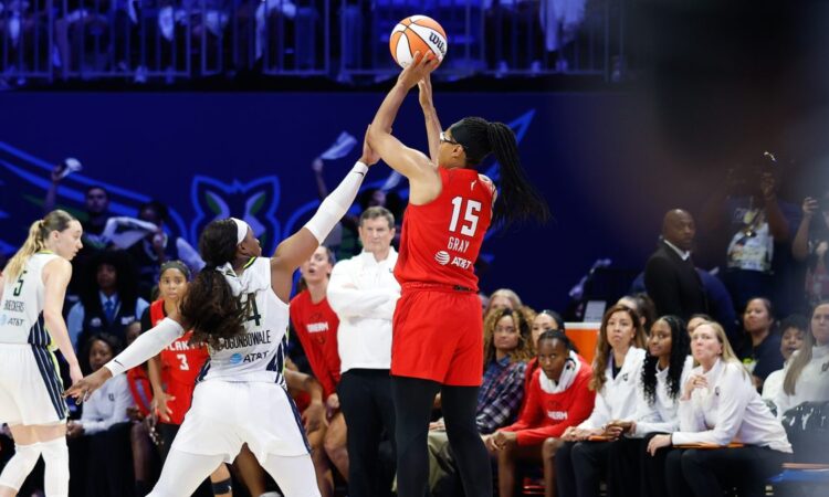 Atlanta Dream guard Allisha Gray shoots over the contest of Dallas Wings guard Arike Ogunbowale at College Park Center