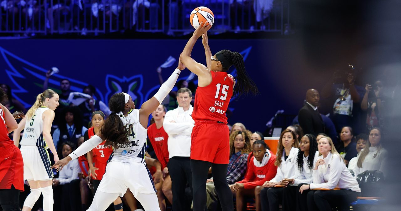 Atlanta Dream guard Allisha Gray shoots over the contest of Dallas Wings guard Arike Ogunbowale at College Park Center