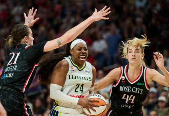 Dallas Wings guard Arike Ogunbowale drives to the basket between Portland Fire defenders Emily Engstler and Karlie Samuelson during the second half at Moda Center on July 22, 2026.