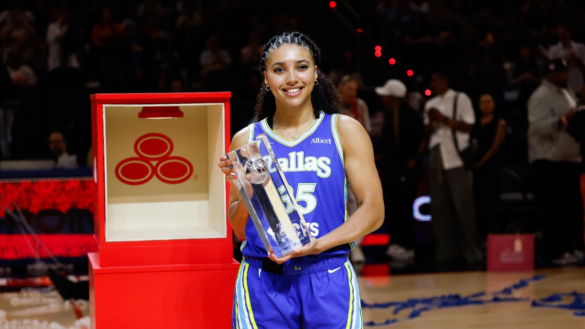 Dallas Wings guard Azzi Fudd holds the 2026 State Farm WNBA 3-Point Contest trophy at Wintrust Arena after the win that prompted her rematch request to Stephen Curry.