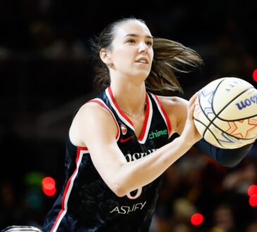 Portland Fire forward Bridget Carleton rises into her shooting motion, holding an All-Star Wilson ball with a rack visible at left, during the 2026 State Farm WNBA 3-Point Contest at Wintrust Arena in Chicago.