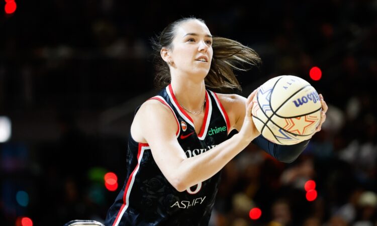 Portland Fire forward Bridget Carleton rises into her shooting motion, holding an All-Star Wilson ball with a rack visible at left, during the 2026 State Farm WNBA 3-Point Contest at Wintrust Arena in Chicago.