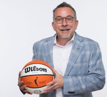 Dallas Wings general manager Curt Miller holds a Wilson WNBA game ball during 2026 Dallas Wings media day at College Park Center.