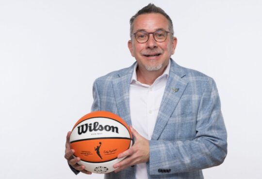 Dallas Wings general manager Curt Miller holds a Wilson WNBA game ball during 2026 Dallas Wings media day at College Park Center.